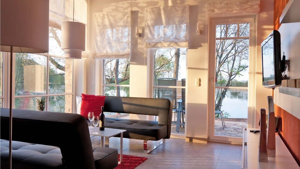 Living area of the vacation apartment osprey with large barn windows, © Andre Pretzel