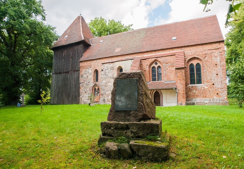 Village church side with memorial stone, © Frank Burger