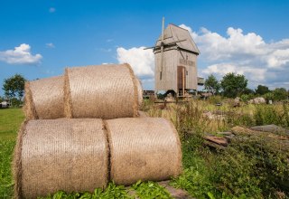 Windmill with straw rolls in the foreground., © Frank Burger