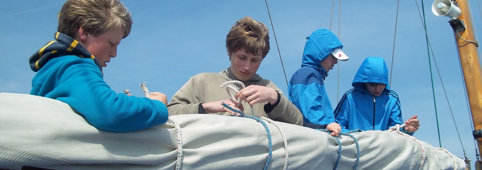 Young people on the chart house, packing the mainsail, © Mirko Niebuhr 2017