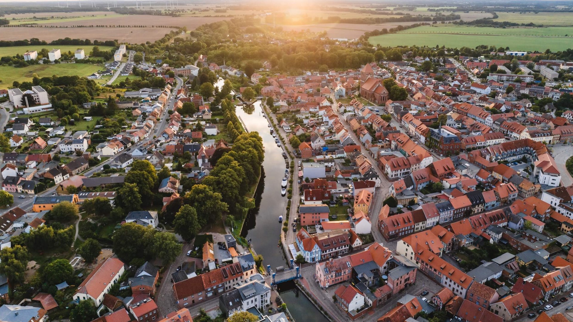 Aerial view of the town of Plau am See at sunset. The lift bridge can be seen in the center.