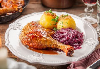 Delicious leg of duck with brown sauce, dumplings and red cabbage, © Karls Markt OHG