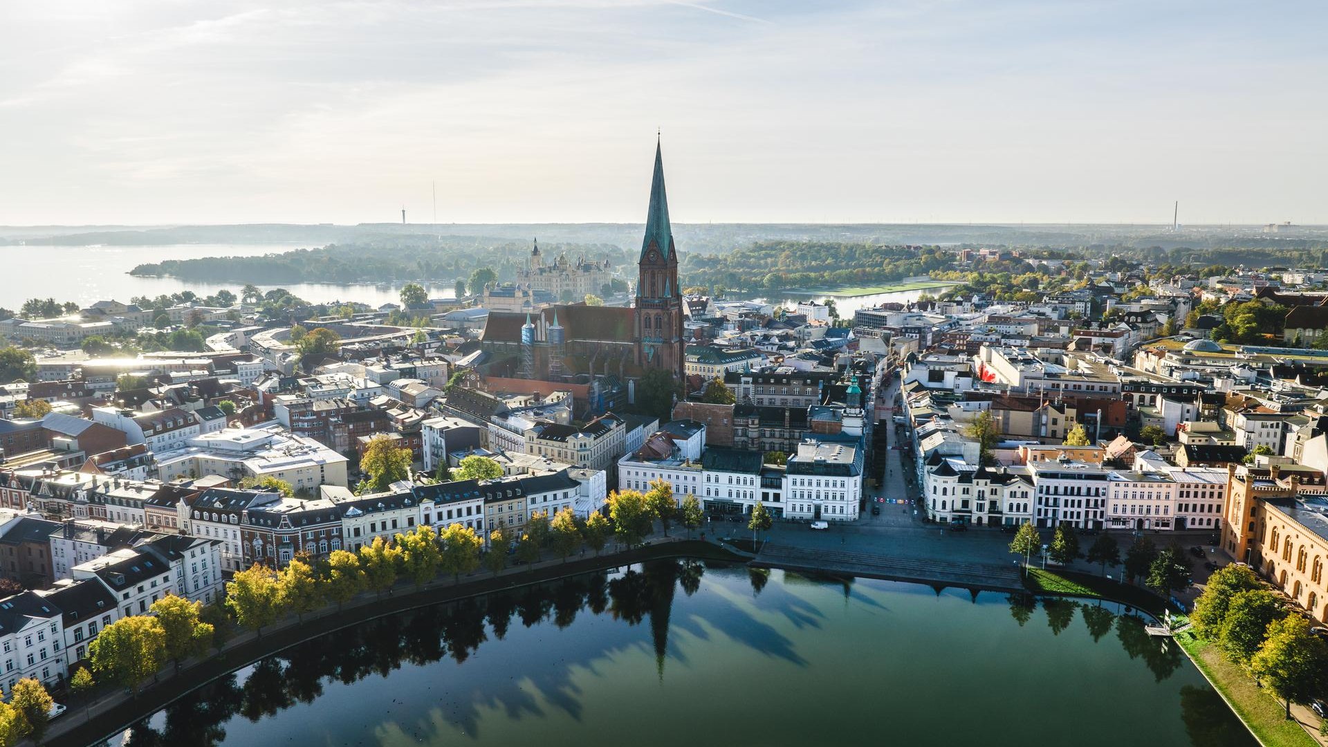 Schwerin city center with dom from the Pfaffenteich at sunrise from the air