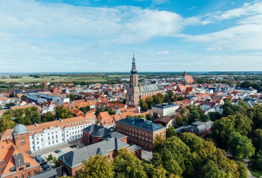 The silhouette of Greifswald from the air and view of the church towers.