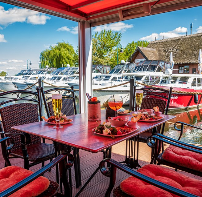 View over the set table to the houseboats, © Orlowski