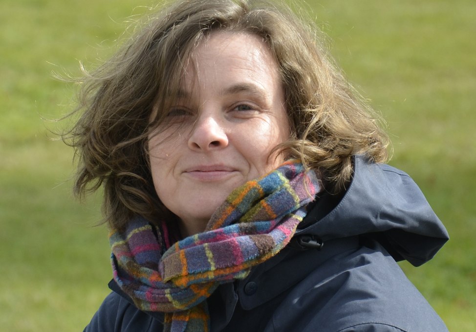 Portrait of Kristina Andres in front of a meadow with jacket and scarf, © Thomas Gallien