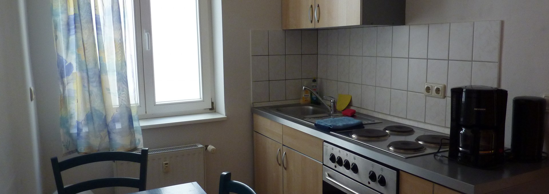 Kitchen with table and washing cabinet, © Galina Diran