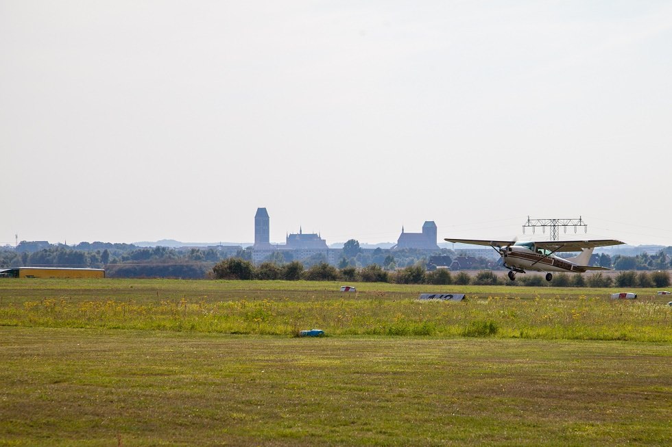 Aircraft at takeoff. In the background the silhouette of Wismar., © Frank Burger