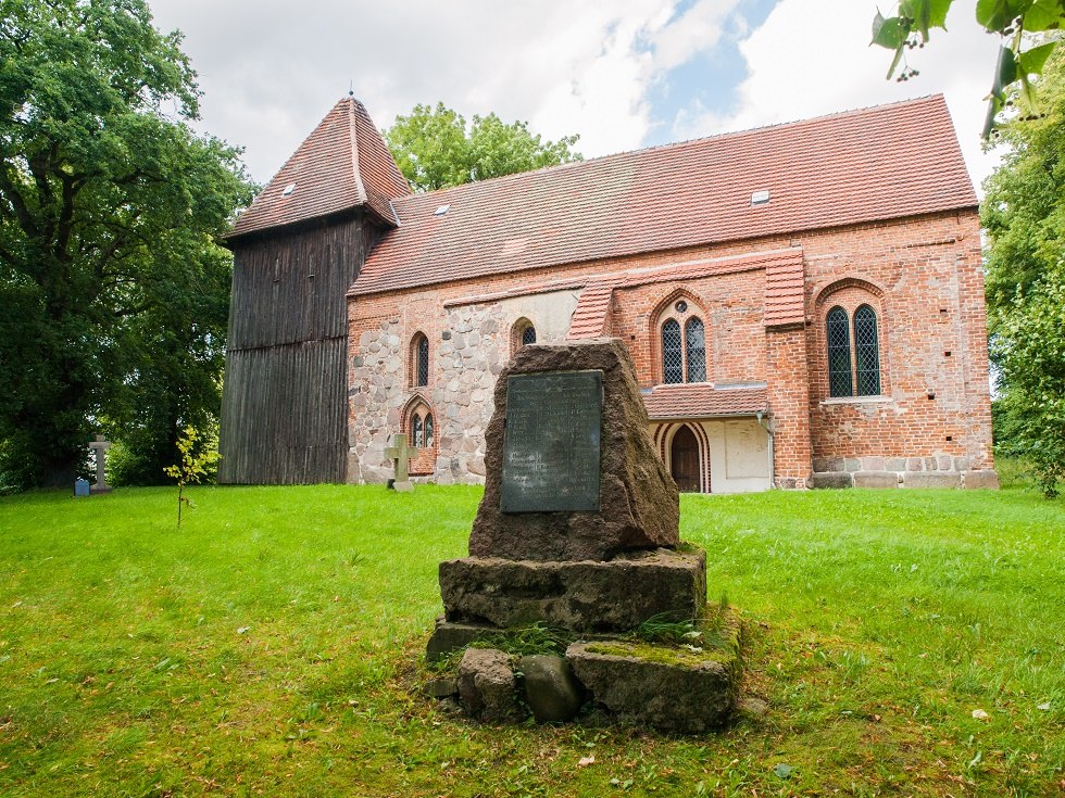 Village church side with memorial stone, © Frank Burger