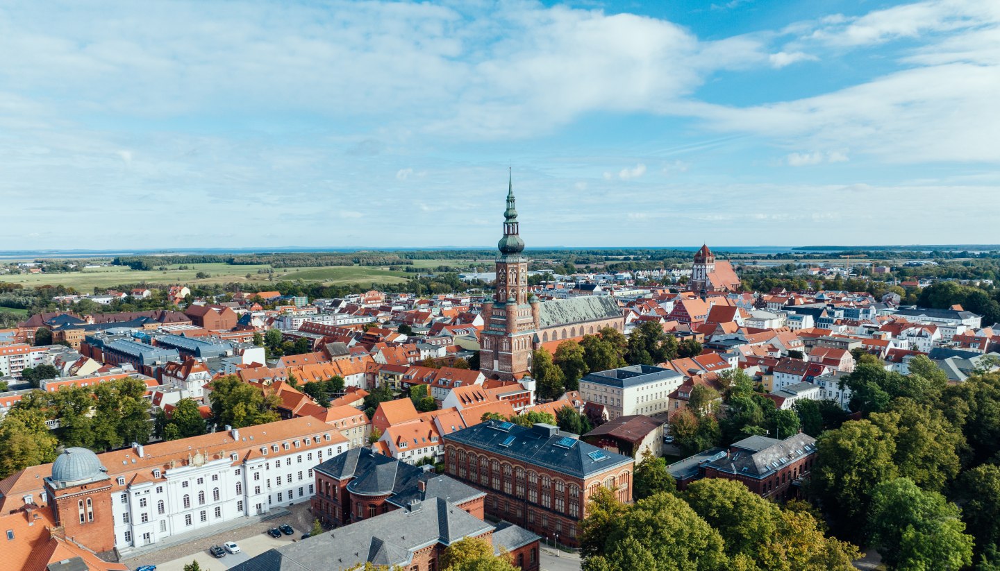 The silhouette of Greifswald from the air and view of the church towers.