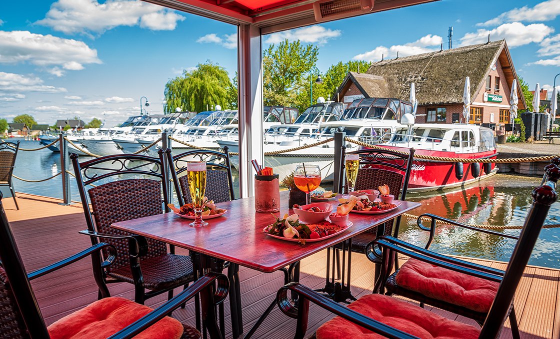 View over the set table to the houseboats, © Orlowski