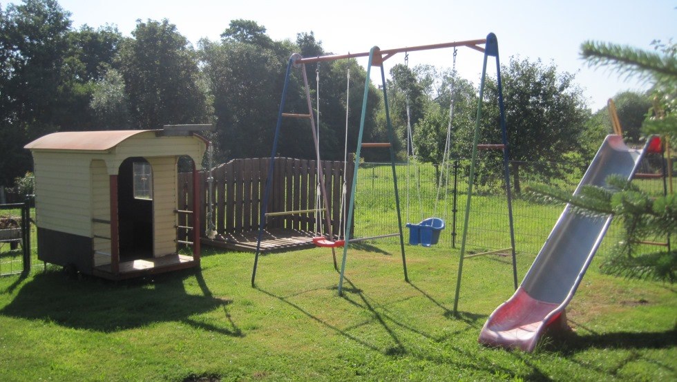 Playground with playhouse, sandbox, swing and slide, © Richter